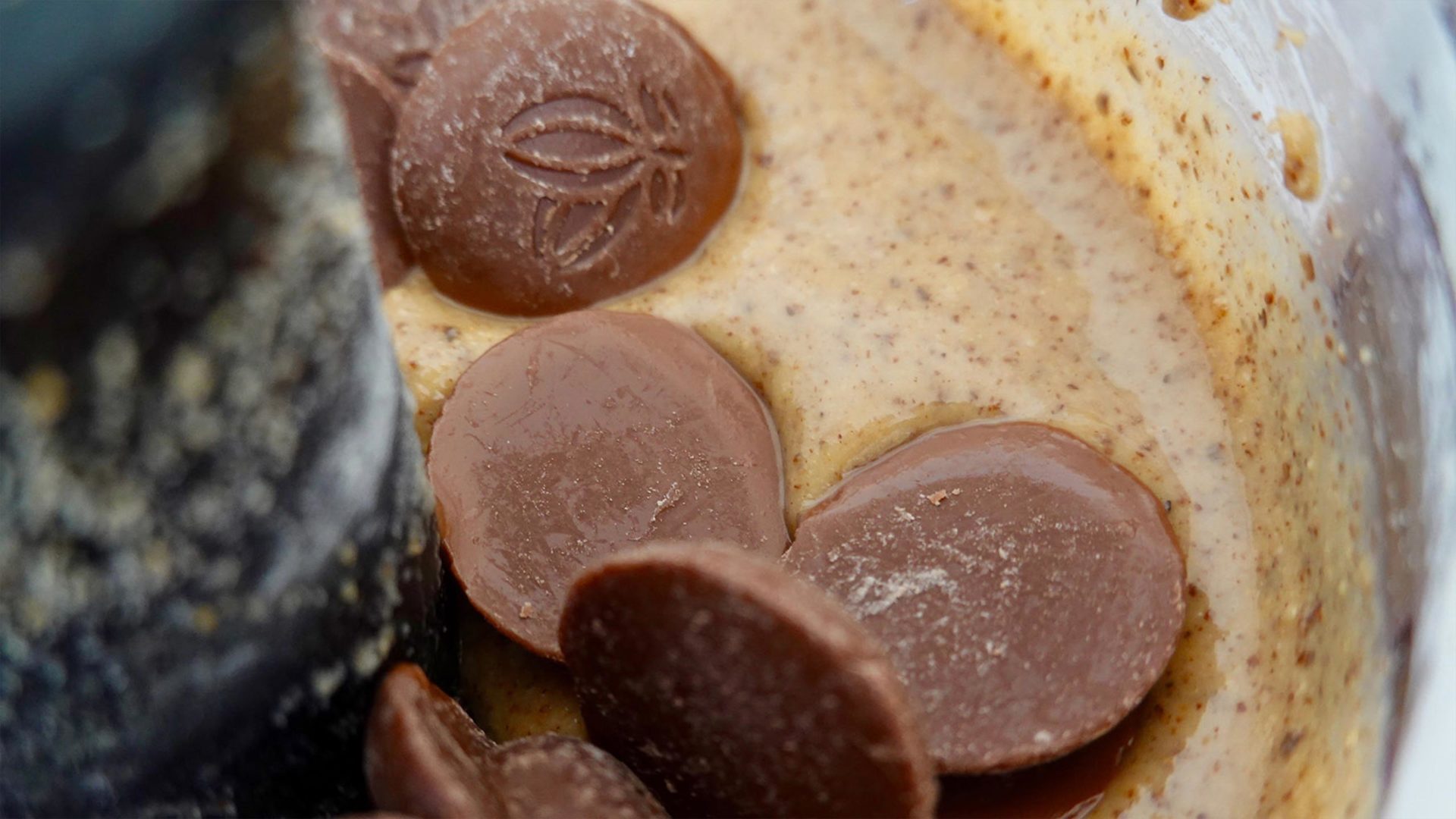 Macro image of nut paste in blender with chocolate chips